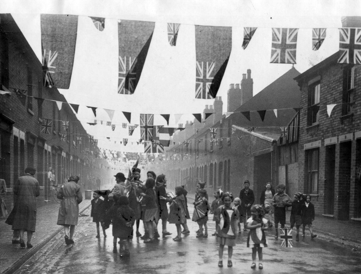 Singing in the rain... May 8, 1945, was wet, but it didn't dampen the ardour of these singing children in a well decorated Gordon Street, Wolverhampton.