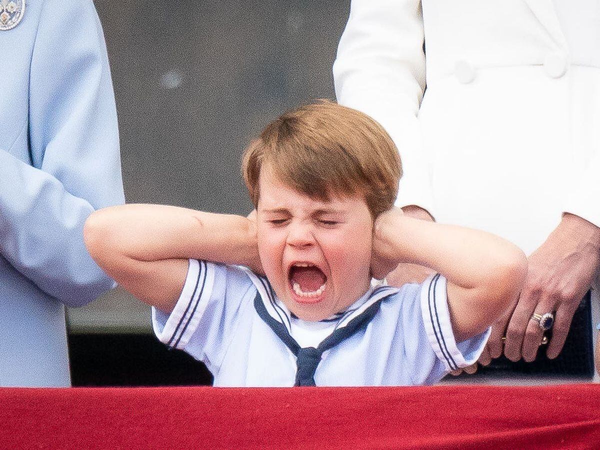 Prince Louis pulls a face on the balcony of Buckingham Palace