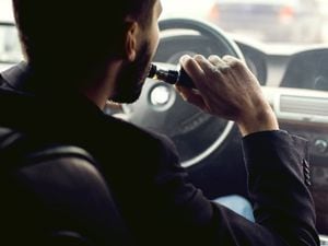 A man vaping while driving