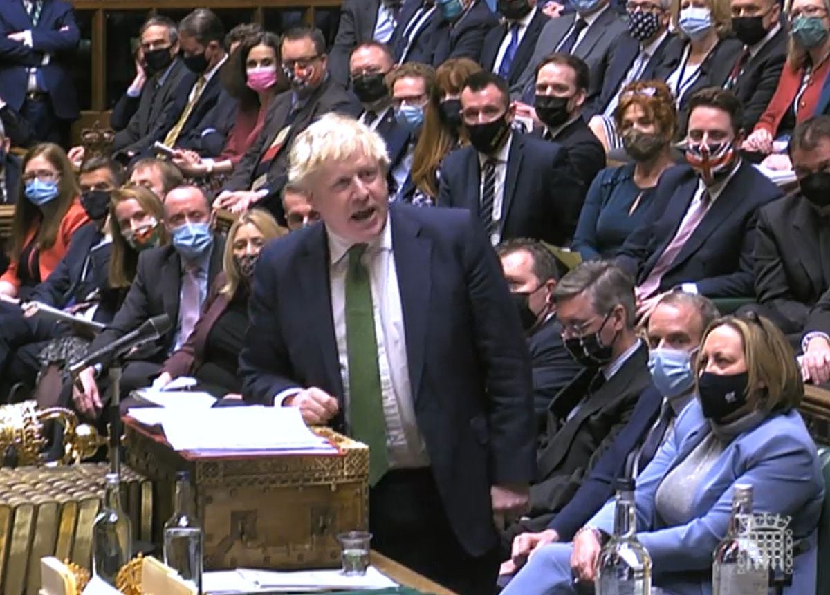 Boris Johnson came under heavy fire at PMQs. Stuart Anderson can be seen leaning forward on the second row behind him, two down from West Bromwich West MP Shaun Bailey, wearing the Union Flag mask