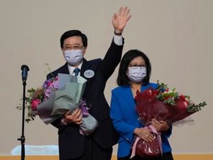 John Lee celebrates with his wife after declaring his victory in the chief executive election of Hong Kong