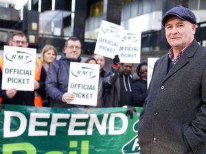 Mick Lynch, general secretary of the Rail, Maritime and Transport union, joins union members on the picket line
