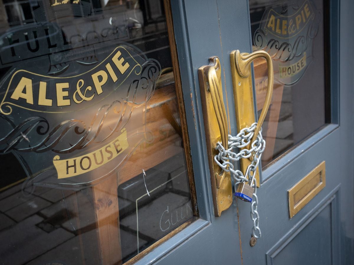 Chains secure the doors of a closed Fuller’s pub in London