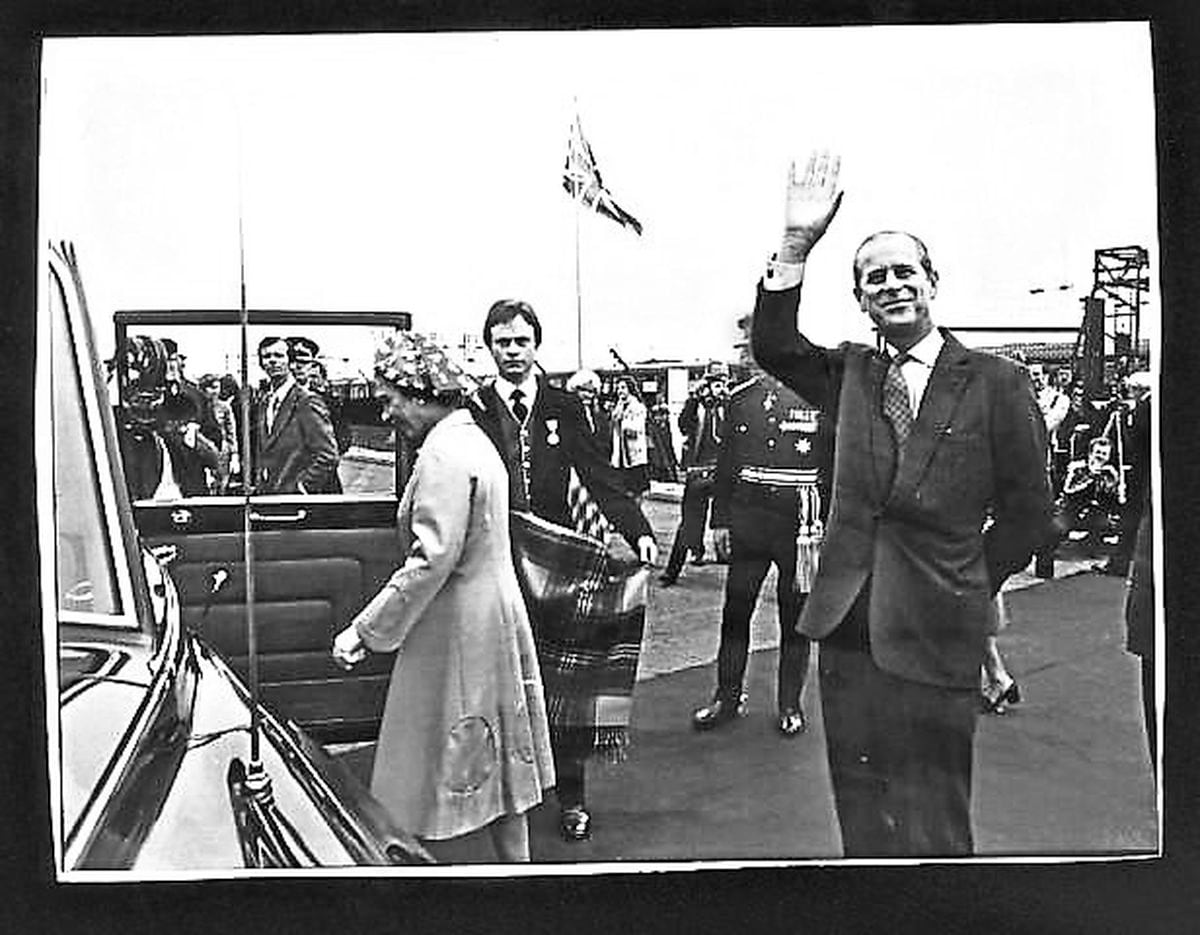 Prince Philip waves as the Queen and he leave Goodyear in Wolverhampton for Dudley in July 1977