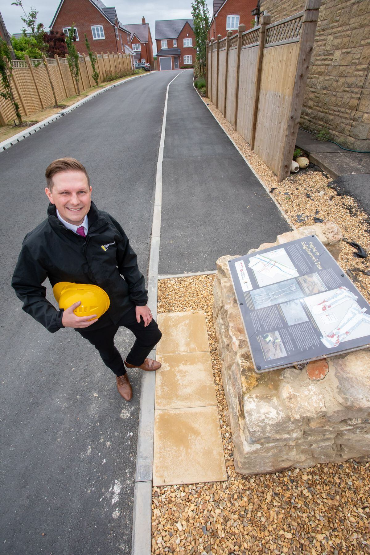  Adam Cadman, of Kendrick Homes, by the mini monument at its Parsons Grove development 