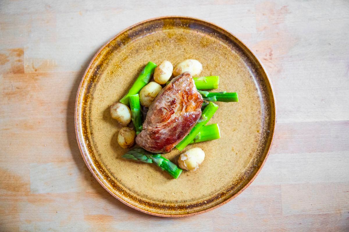Pork neck, served with seasonal Jersey Royals and asparagus with a butter and herb sauce