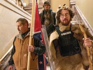 Supporters of President Donald Trump, including Aaron Mostofsky, right, who is identified in his arrest warrant, walk down the stairs outside the Senate Chamber in the US Capitol in Washington on January 6 2021