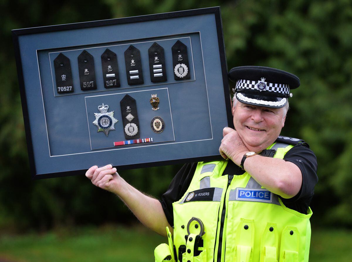 Retiring Special Chief Officer Mike Rogers shows off the framed epaulettes he was given by West Midlands Police