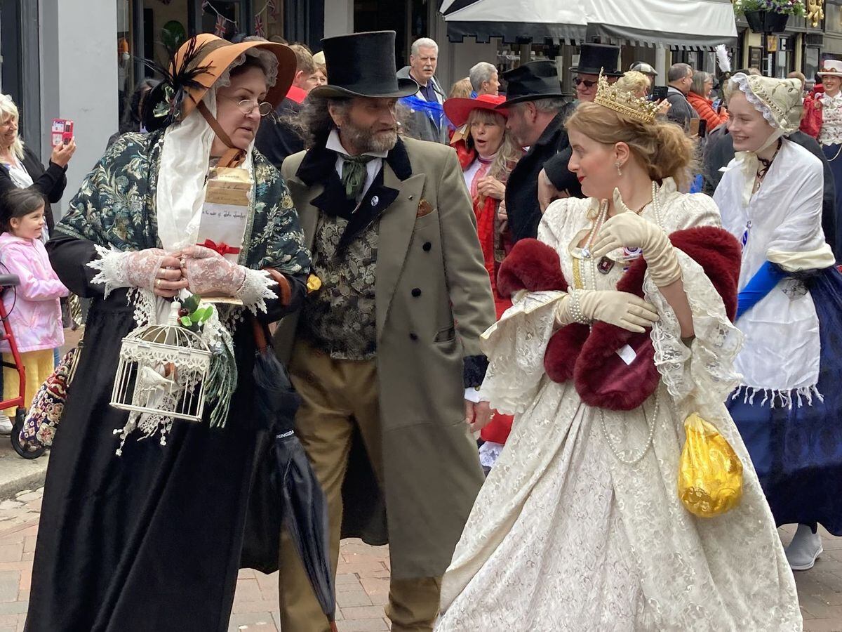 People dressed as Dickensian literary characters take part in parade at the Platinum Jubilee Dickens Festival in Rochester
