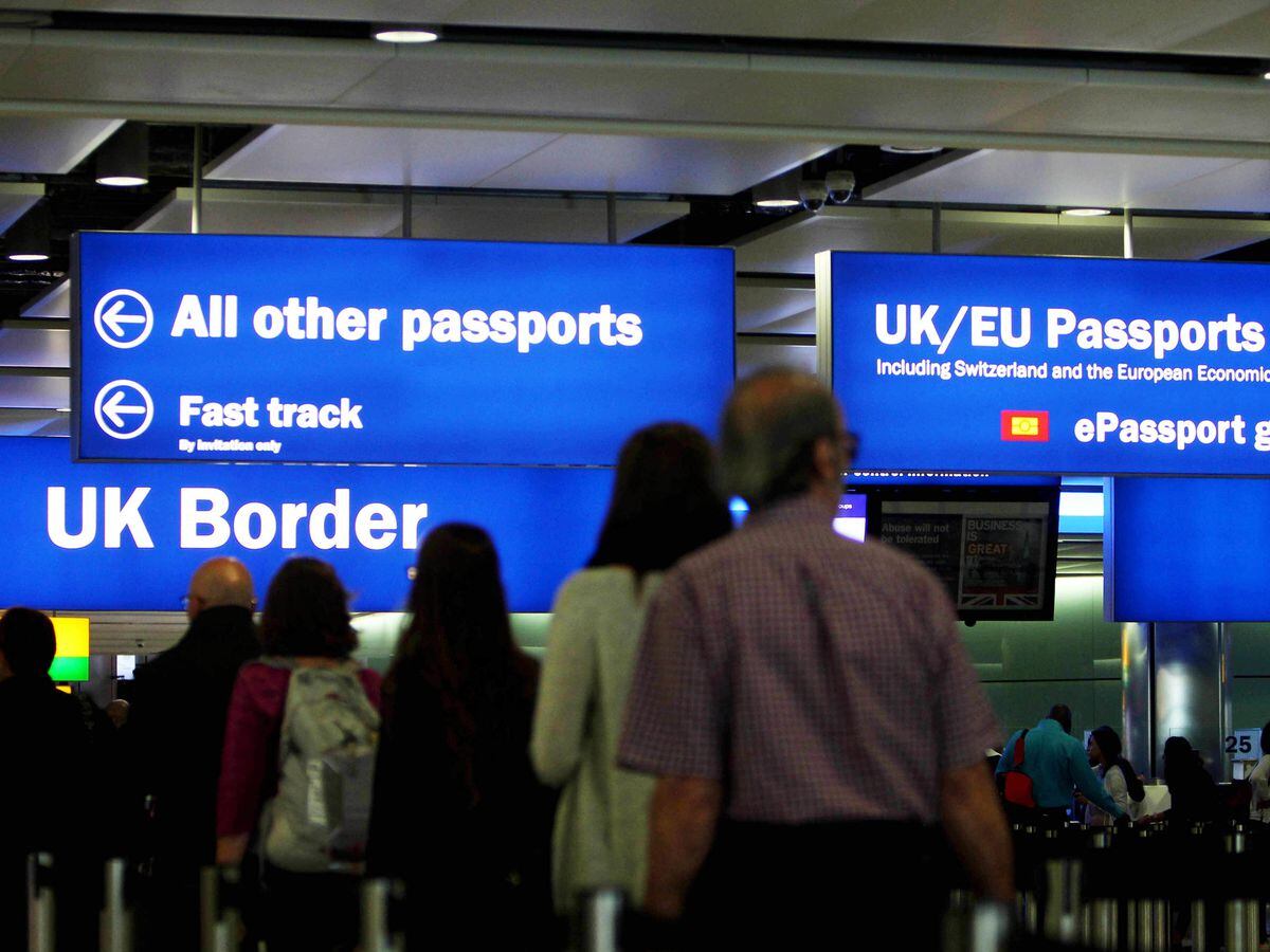 Passengers going through UK border checks at an airport