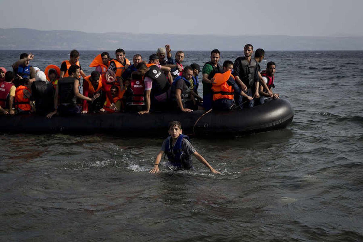 Syrians arrive in Lesbos, where the island has been transformed by the sudden arrival of around 20,000 refugees and migrants