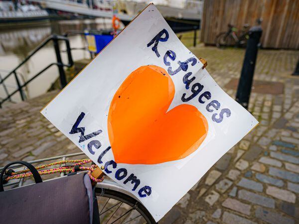 A ‘refugees welcome’ banner attached to a bicycle by a small flotilla of boats leaving Bristol harbour in support of Ukrainian refugees during a day of national action showing support for refugees. (Ben Birchall/PA)