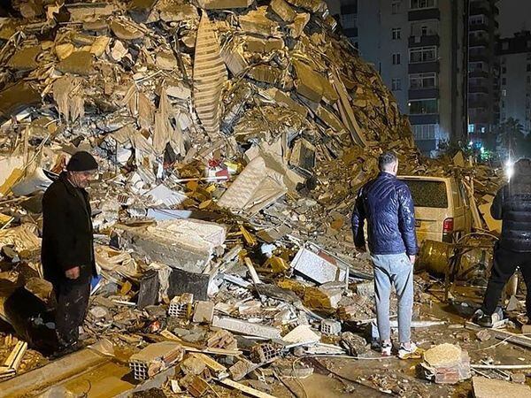 People try to reach trapped residents inside collapsed buildings in Diyarbakir, southern Turkey