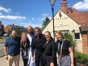 Superstar Barry Manilow with staff from The Swallows Nest in Romsley, Halesowen where he popped in for cod and chips