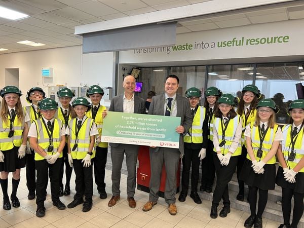Steve Mitchell from Veolia (left) with Tim Cooper, head of service, waste and sustainability at Staffordshire County Council and pupils from Brewood Middle School who got a tour of the facility.