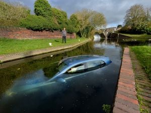 Kevin Davenport, from Halesowen, looks on at the car in Dudley Canal, Brierley Hill. 