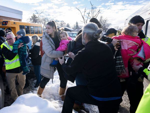 Families wait for news after a bus crashed into a daycare centre in Laval, Quebec