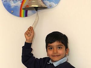 Aaron Parmar rings the bell to signal the end of his cancer treatment.