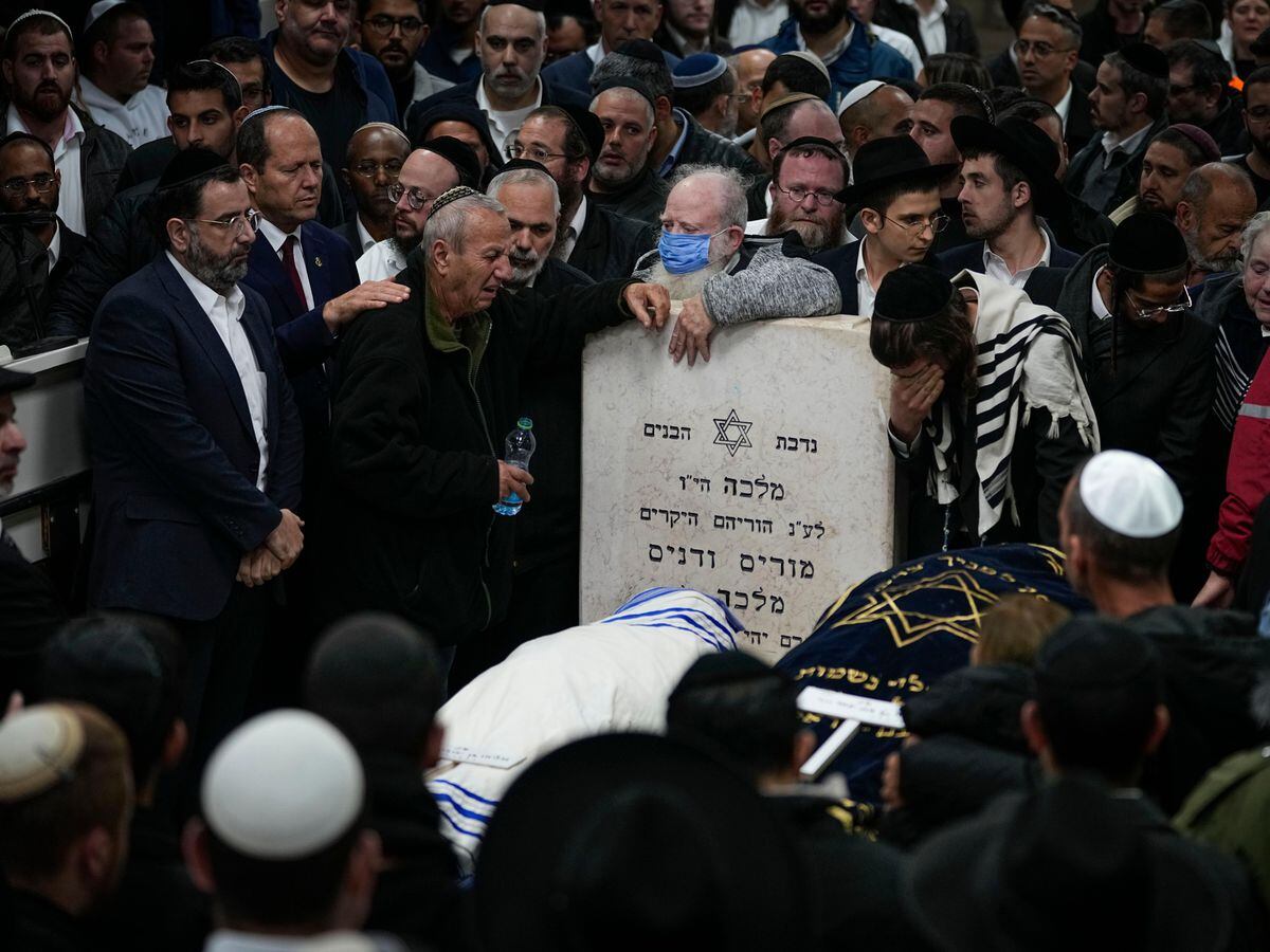 Mourners at the funeral of an Israeli couple killed in a gun attack outside a synagogue in Jerusalem