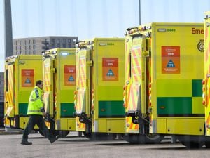 A paramedic walks past parked ambulances as they await the first patients at the ExCel centre in London which is being made into the temporary NHS Nightingale hospital to help tackle coronavirus. PA Photo. Picture date: Wednesday April 1, 2020. A total of 1,789 patients have now died overall in UK hospitals as of 5pm on Monday, the Department of Health said, up by 381 from 1,408 the day before. See PA story HEALTH Coronavirus. Photo credit should read: Stefan Rousseau/PA Wire.