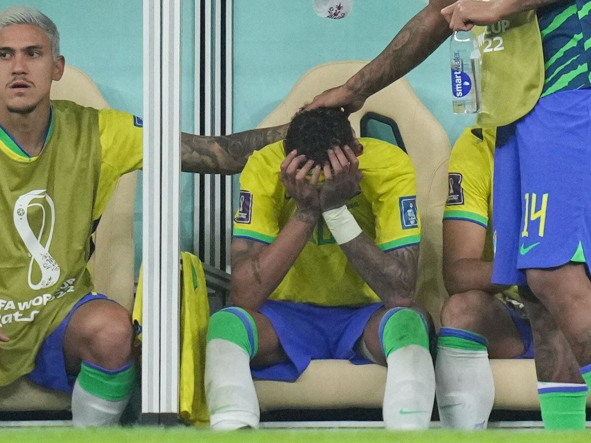 Neymar looks dejected on the bench after suffering an ankle injury