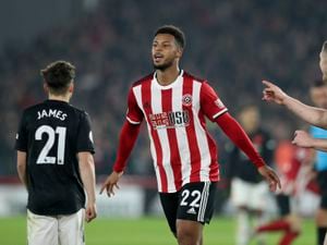 Sheffield United's Lys Mousset, center, celebrates after scoring his side's second goal during the English Premier League soccer match between Sheffield United and Manchester United at Bramall Lane Stadium in Sheffield, England, Sunday, Nov. 24, 2019. (AP Photo/Jon Super).