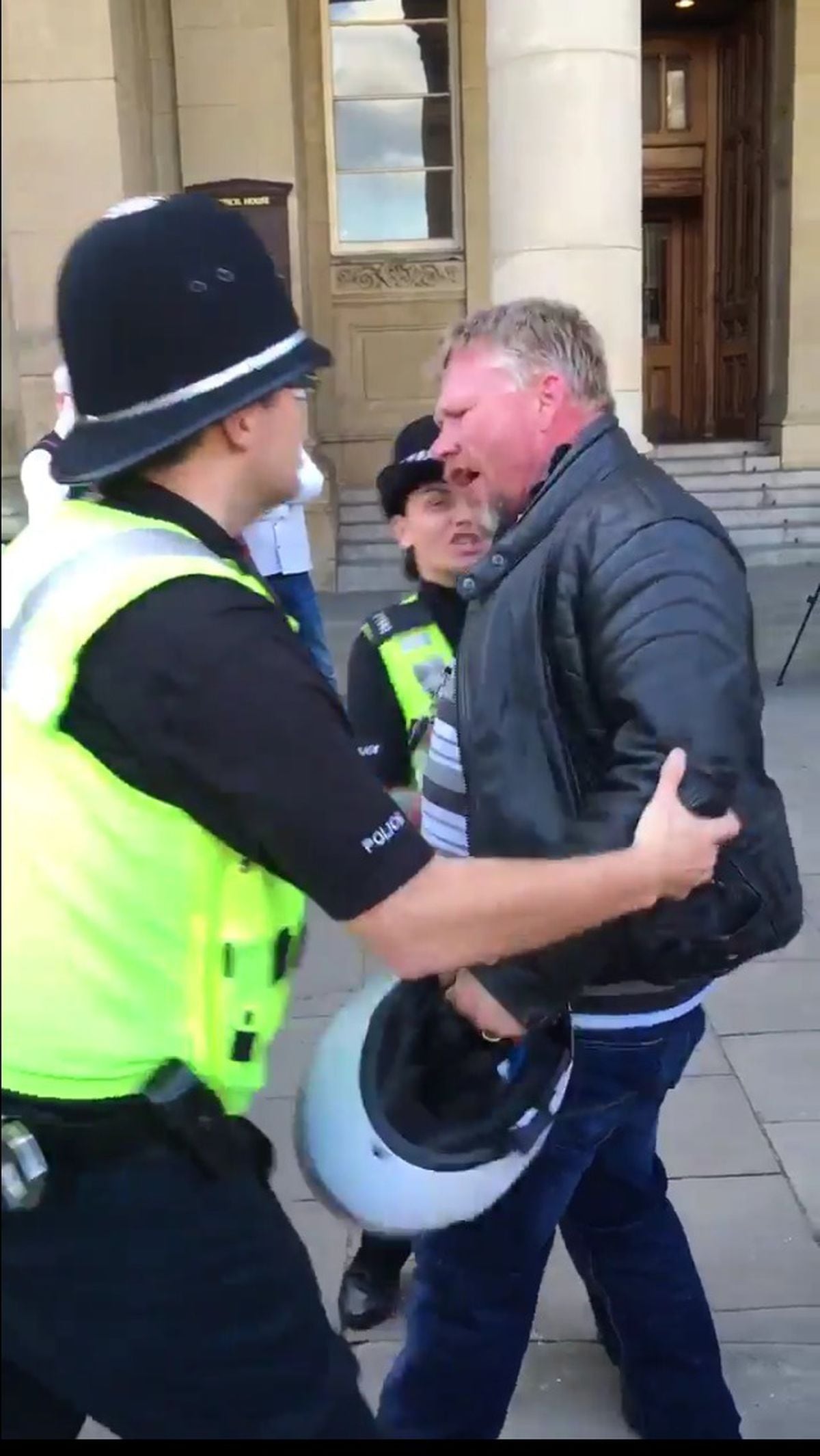 A member of the public had to be restrained after he reacted angrily to an anti-war speaker