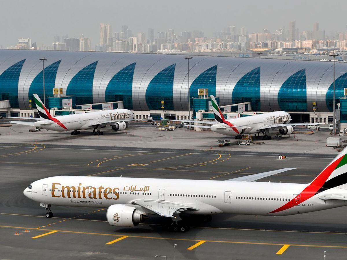 An Emirates plane taxis to a gate at Dubai International Airport