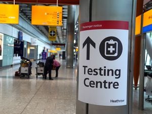 A sign directs passengers to a testing centre in Terminal 5 at Heathrow Airport in west London
