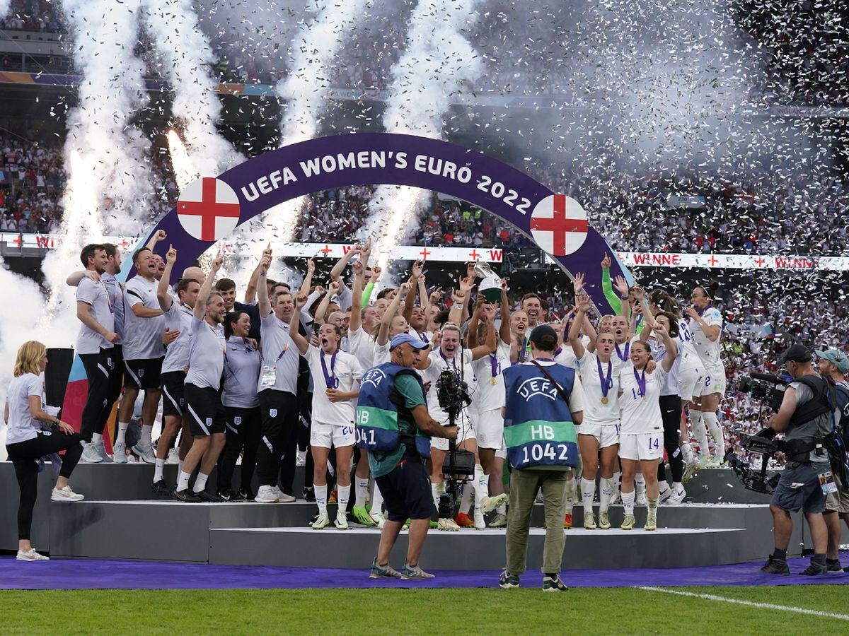 England players celebrate with the trophy following victory over Germany