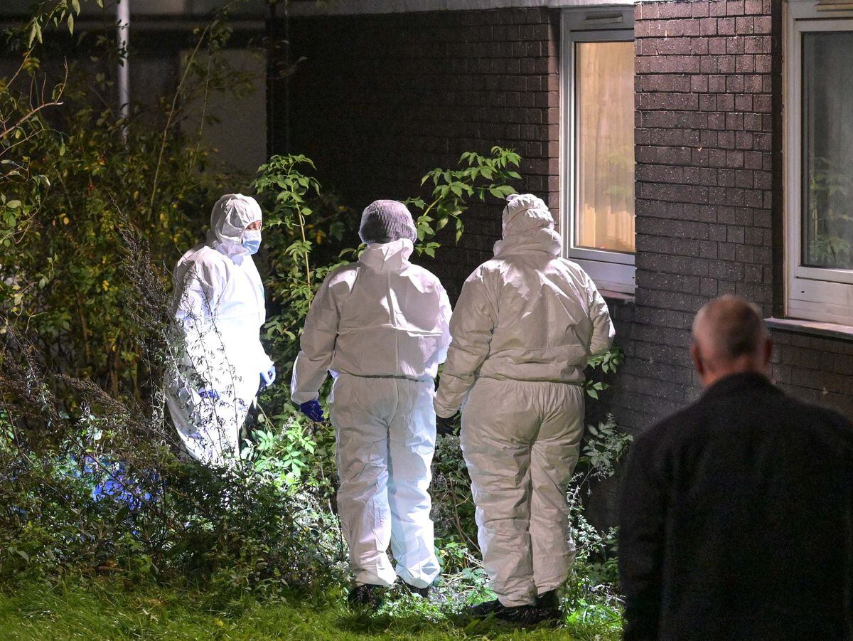 Forensic officers outside Hawthorn House in Heath Town after the man was found dead. Photo: SnapperSK