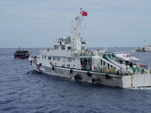 A Chinese coastguard ship tries to block the way of a Philippine supply boat, left, as it heads towards Second Thomas Shoal, locally known as Ayungin Shoal, in August