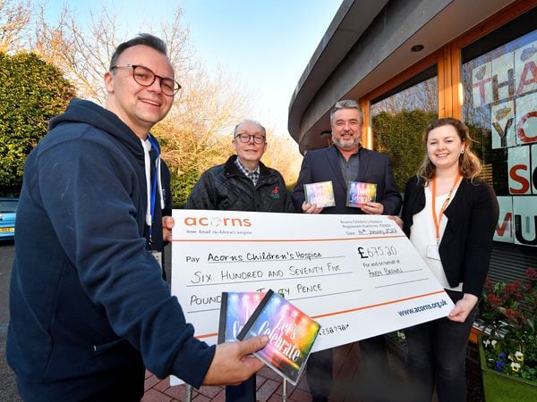 WALSALL COPYRIGHT MNA MEDIA TIM THURSFIELD 14/01/22.Toby Mobberley(left) and Kate Vousden from Acorns, Walsall, accept a cheque from Andy Brown and Nick Durell, who riased money for the hospice from the sales of a CD and cabaret show...