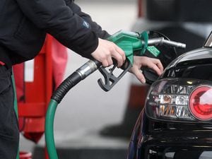 File photo dated 22/02/13 of a person using a petrol pump. According to FairFuelUK savings worth an estimated &pound;145 million were denied to drivers in the past month because fuel retailers failed to pass on cuts in wholesale prices.