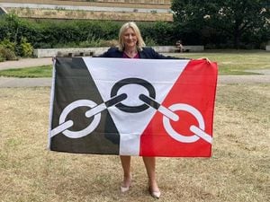 Suzanne Webb celebrates Black Country day by holding the flag upside down