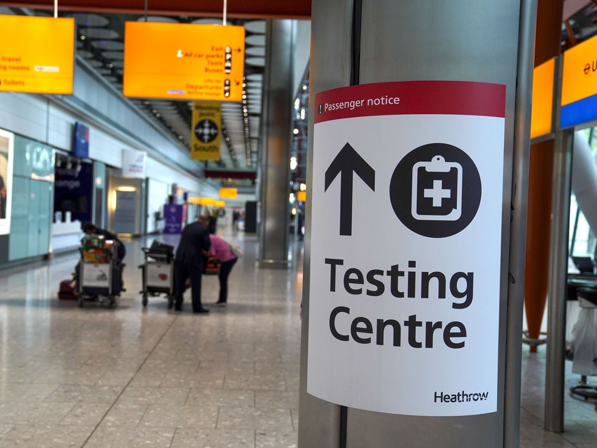 A sign directs passengers to a testing centre at Heathrow Airport