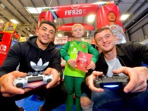 Josh Gordon and Liam Roberts with seven-year-old Dan Tyas from Wednesbury ready for the Fifa 20 clash