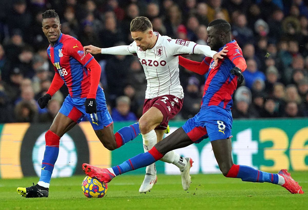 Aston Villa's Matty Cash (centre) battles for the ball with Crystal Palace's Wilfried Zaha (left) and Cheikhou Kouyate