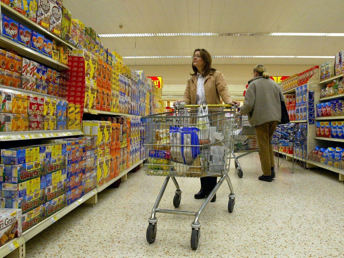 Shoppers in a supermarket aisle