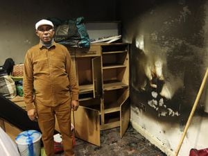 Pastor Tony Adams checks a smoke-logged room at Mountain of Fire and Miracles Ministries, in Town Hill, Walsall
