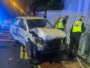 The car after it crashed into a fence. Photo: West Midlands Fire Service