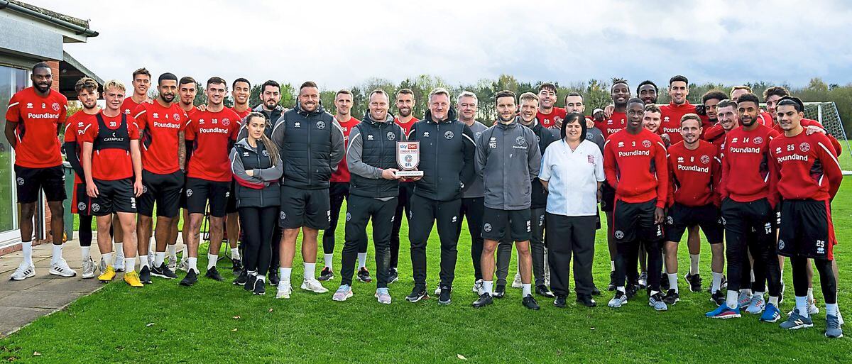 Walsall boss Michael Flynn celebrates his October manager-of-the-month award with the rest of his backroom team and the Saddlers squad
