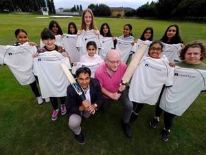 Amish Dudhia (Chairman of Sponsorship) and Nick Bryers (coach) with members of Walsall Cricket Club's girls' team