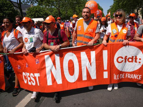 Demonstrators march holding a placard reading 'No!' in Paris, France