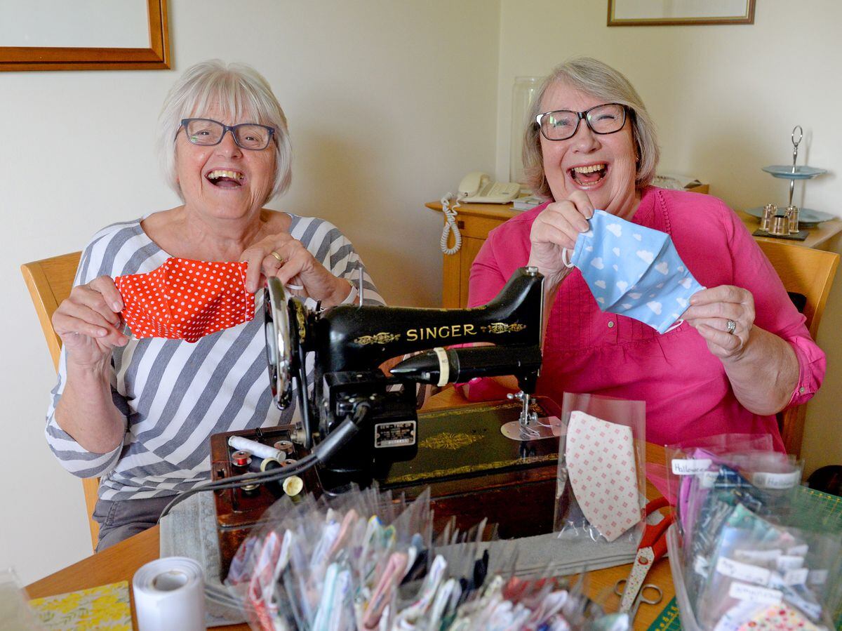 Sue Harrison and Maureen Warrilow pictured with the 1934 Singer sewing machine they are now using to make the masks
