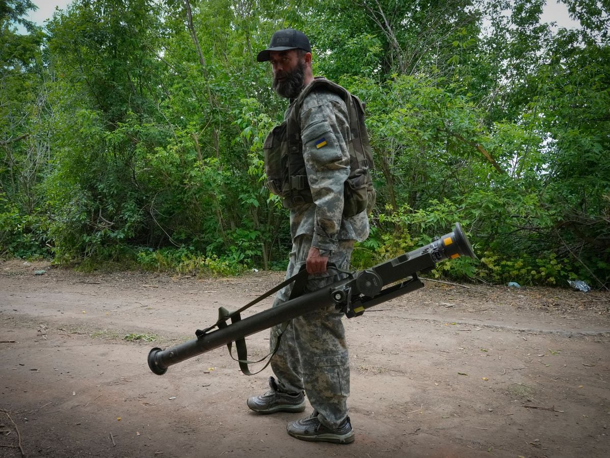 A Ukrainian soldier carries a US-supplied Stinger as he goes along the road in Ukraine’s eastern Donetsk region