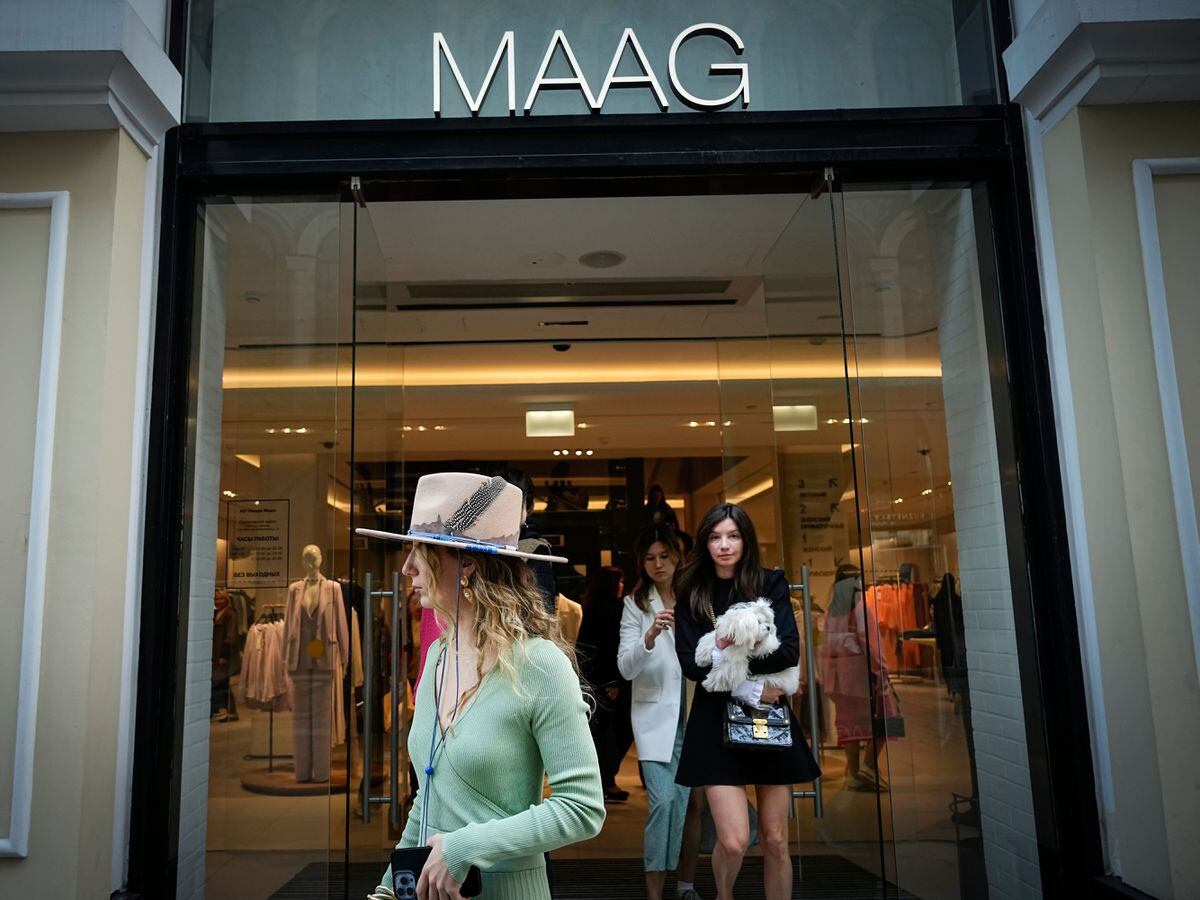 A woman exits Maag, a former Zara flagship store, in Moscow, Russia