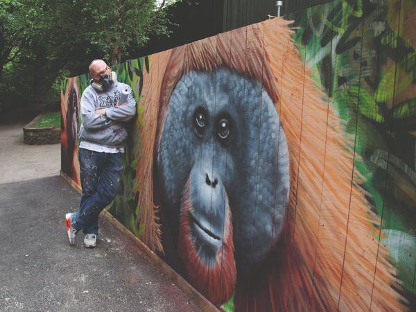 Artist David Brown with the new orangutan graffiti wall