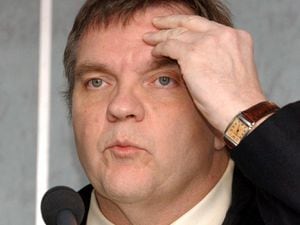 Meatloaf touches his forehead during a press conference