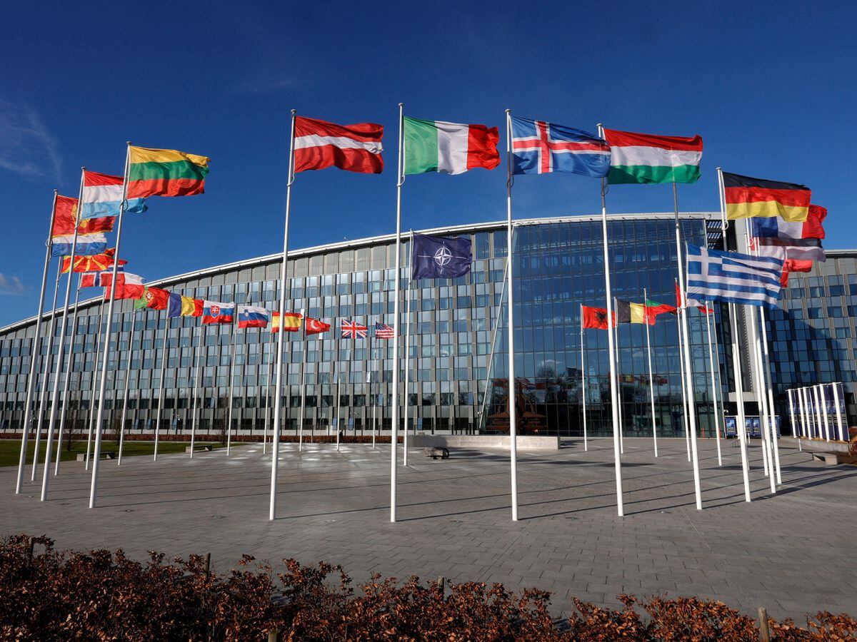 Flags flutter in the wind outside Nato headquarters in Brussels